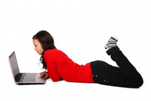11706-a-beautiful-girl-lying-on-the-floor-with-a-laptop-isolated-on-a-white-b-pv